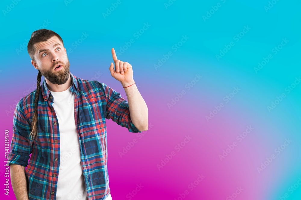 Naklejka premium Portrait of attractive man pointing fingers at background.