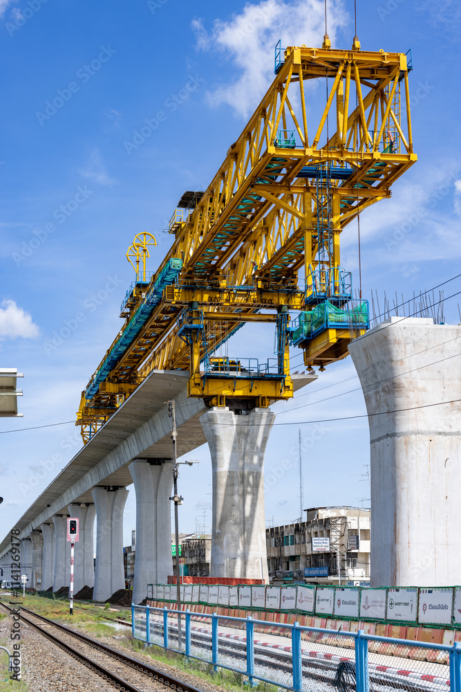 Fototapeta premium New construction site with crane and mechanical equipments on sunset daylight background. construction industry.High-speed train of Chinese made FuxingHao, base from CR400AF For Thailand.