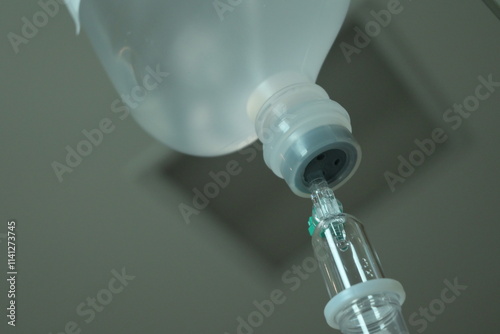 saline solution drip for patient and infusion pump in hospital, close up equipment of medicine photo