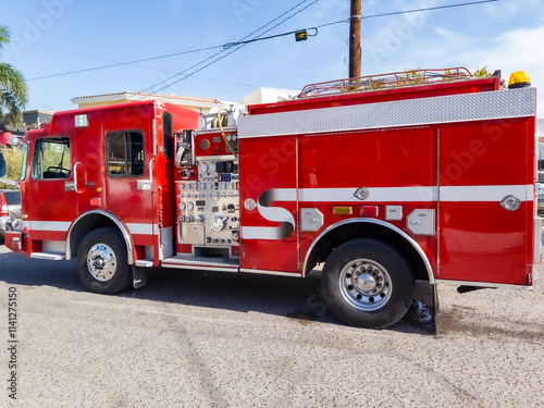 A nice red fire truck on a street photo