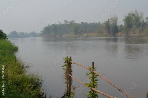 Wooden boat,
Green boat,
Small boat,
River boat,
Fishing boat,
Mounted boat,
Tied boat,
Bamboo pole,
Board,
Paddle,
Riverside,
Riverside,
Countryside landscape,
Nature landscape,
Smorning on the river photo