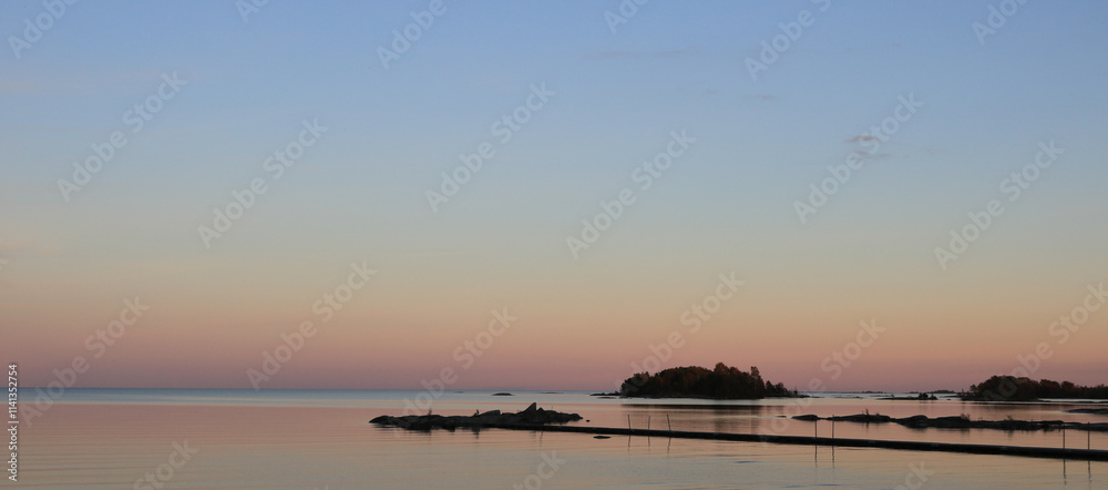 Autumn evening in Vita Sannar, pink sky over Lake Vanern and small island, Sweden. Autumn evening in Vita Sannar, pink sky over Lake Vanern and small island, Sweden.