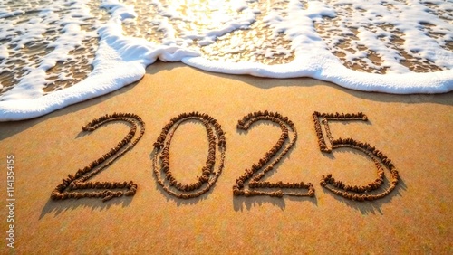 A sandy beach with the year 2025 written in the sand with with sea waves, top view. 2025 Happy new year, celebration, banner or greeting card