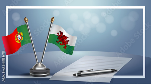 Portugal and Wales National flags on small table with bokeh background, cooperative relationship
