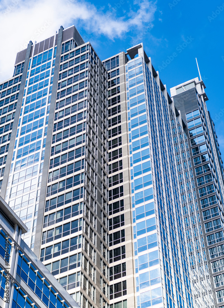 Obraz premium Glass skyscraper. City architecture. Architecture of modern office building. Perspective city skyscraper. Business skyscraper building. Architectural building in business area. Designing structures
