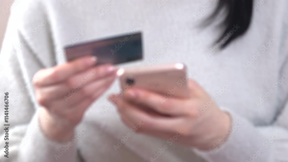 Defocus, Closeup of a Woman’s hands Holding a Credit Card and Entering Card Information on a Smartphone. 4K