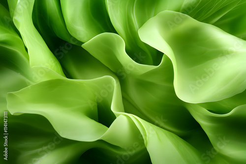 Close-up of vibrant green leaves with smooth, flowing textures and organic patterns. photo