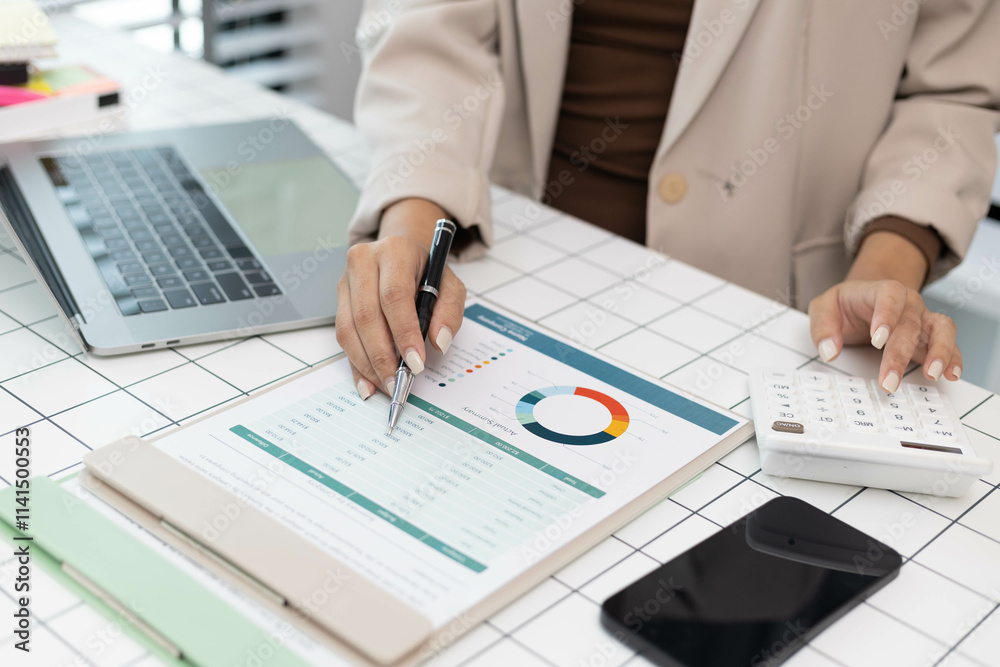 A woman is pointing at a graph on a piece of paper. The graph shows a comparison between two sets of data. The woman is using a pen to highlight the differences between the two sets of data A woman is pointing at a graph on a piece of paper. The graph shows a comparison between two sets of data. The woman is using a pen to highlight the differences between the two sets of data