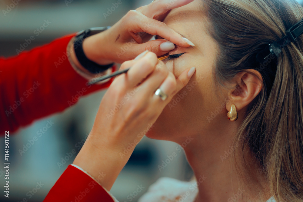 Obraz premium Professional Makeup Artist Making Perfect Eye wing with Liner. Woman wearing perfect eye makeup for everyday casual fashion look 
