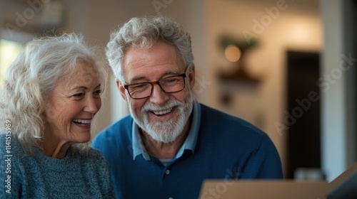 Happy elderly couple enjoying time together while sorting through family memories and helping each other in a cozy home environment