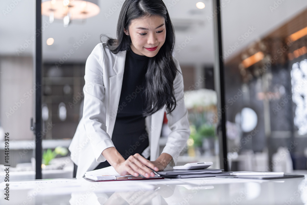Beautiful confident asian business woman Auditor or internal revenue service staff, Business women checking annual financial statements of company. Audit Concept. Beautiful confident asian business woman Auditor or internal revenue service staff, Business women checking annual financial statements of company. Audit Concept.