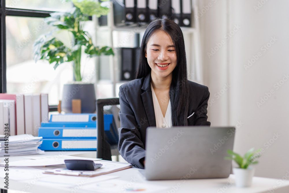 Happy busy young business woman entrepreneur in office using laptop at work, smiling professional asian female company executive manager working looking at computer at workplace. Happy busy young business woman entrepreneur in office using laptop at work, smiling professional asian female company executive manager working looking at computer at workplace.