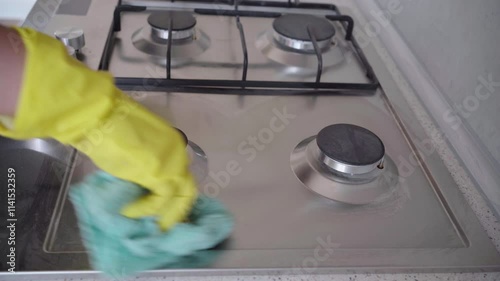 cleaning a gas stove in the kitchen