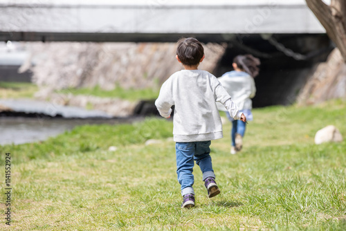 Naklejka 公園を走る男の子の後ろ姿