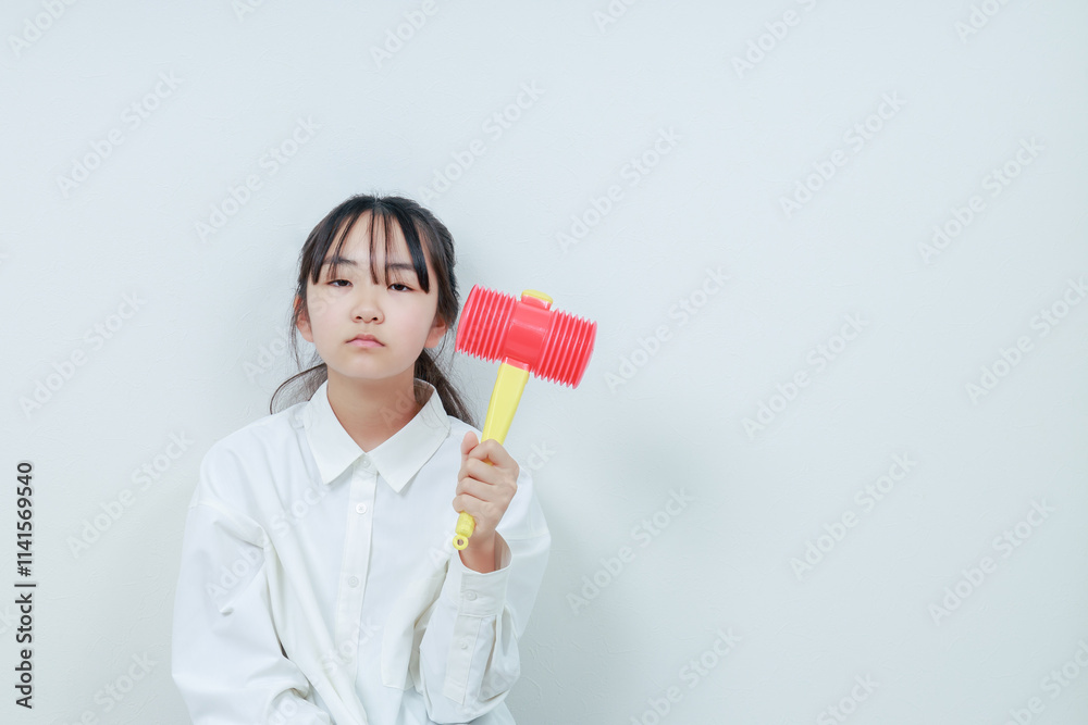 左手にハンマーを握る無表情の女の子 左手にハンマーを握る無表情の女の子