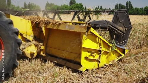 The grain harvester works efficiently in the wheat field during the harvest season.