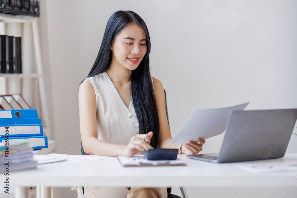 Young business asian woman working at office with documents on desk, doing planning analyzing the financial report, business plan investment, finance analysis concept Young business asian woman working at office with documents on desk, doing planning analyzing the financial report, business plan investment, finance analysis concept