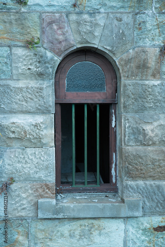old window with bars in a sandstone block wall in Brisbane Queensland Australia