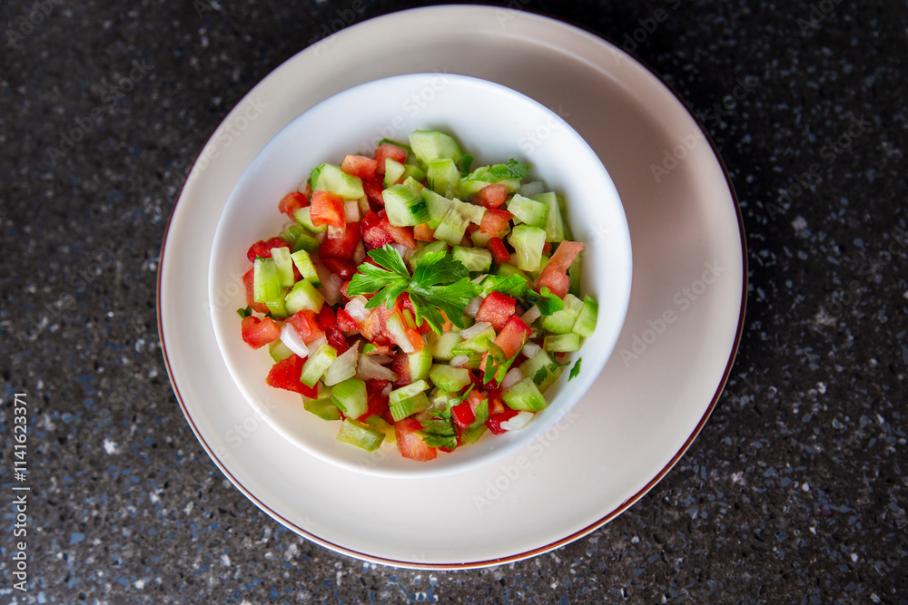Fresh salad with cucumber, tomato, onion, parsley and olive oil close-up top view Fresh salad with cucumber, tomato, onion, parsley and olive oil close-up top view