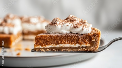 Wallpaper Mural Slice of traditional pumpkin pie topped with whipped cream being held on a spatula on light background  Torontodigital.ca