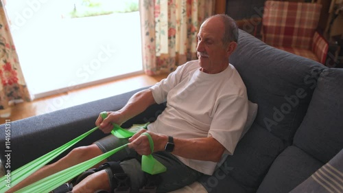 Caregiver giving glass of water to senior man while engages in various exercises utilizing resistance bands in a cozy and inviting living room setting at home. Horitzontal photo