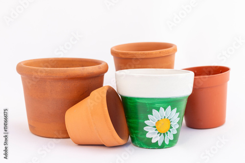 Set of empty small miniature clay flower pots isolated on white background photo