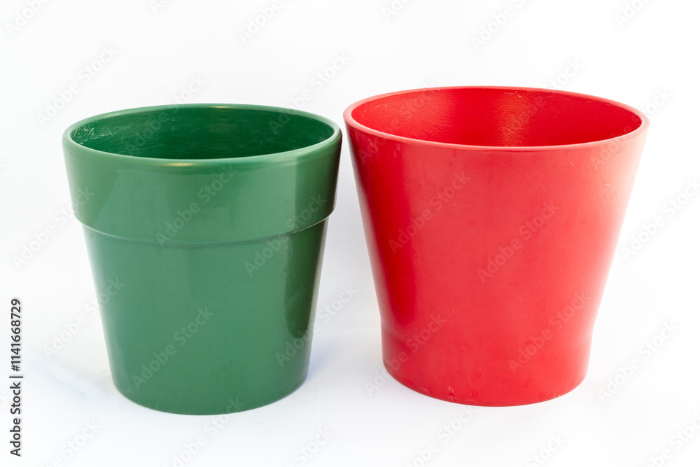 Assorted ceramic red and green flower pots for gardening and home decor on isolated white background Assorted ceramic red and green flower pots for gardening and home decor on isolated white background