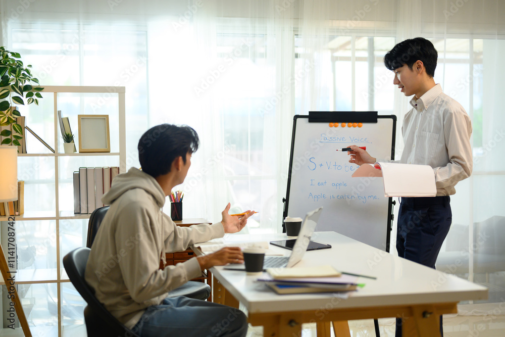 Tutor explaining grammar rules on a whiteboard while student listens and asks questions Tutor explaining grammar rules on a whiteboard while student listens and asks questions
