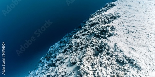 Wallpaper Mural Aerial View of Snow-Covered Terrain with Textured Patterns and Deep Blue Water Background Torontodigital.ca