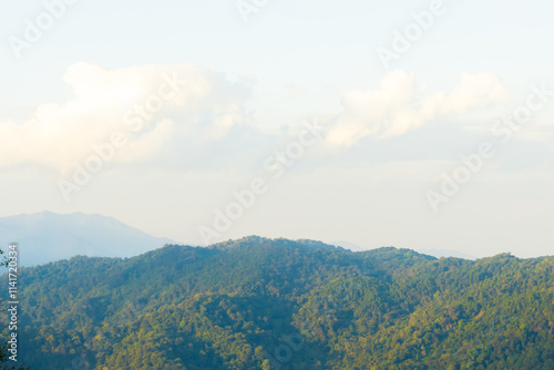 serene mountain landscape with lush green hills and soft clouds. tranquil scene evokes sense of peace and natural beauty, perfect for nature lovers