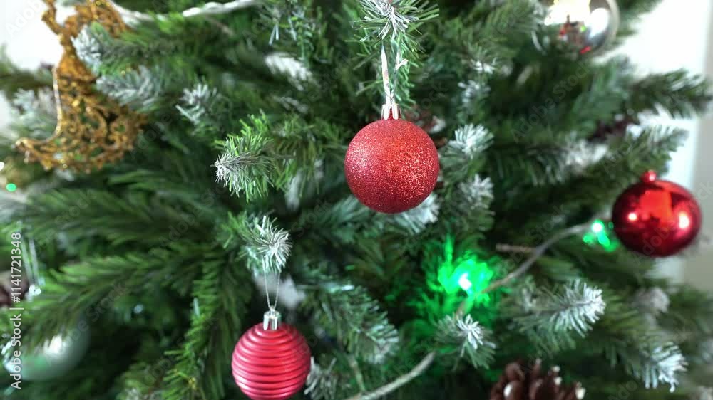 A decorated Christmas tree decorated with a glowing garland. A decorated Christmas tree decorated with a glowing garland.