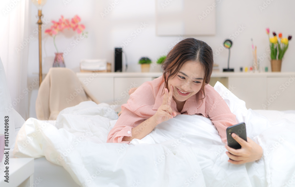 Asian young woman relaxing before bedtime on the bed in the bedroom Asian young woman relaxing before bedtime on the bed in the bedroom