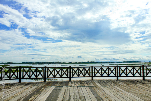 Very interesting photo spot of wooden bridge with dam and blue sky background