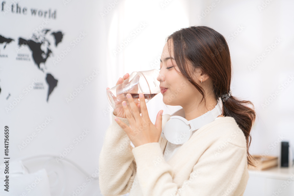 Asian young woman enjoying bread and coffee for breakfast at home, morning routine before work Asian young woman enjoying bread and coffee for breakfast at home, morning routine before work