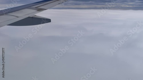 flying through sea of clouds airplane descending into cloud wing view video 4k footage