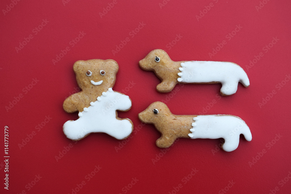 Decorated gingerbread bear and dachshunds on a red background Decorated gingerbread bear and dachshunds on a red background