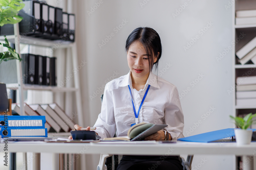 Asian woman hand using calculator to calculate doing finance, budgeting and tax calculation. finance, accounting with laptop computer on table, budget management, monthly expenses
Asian woman hand using calculator to calculate doing finance, budgeting and tax calculation. finance, accounting with laptop computer on table, budget management, monthly expenses