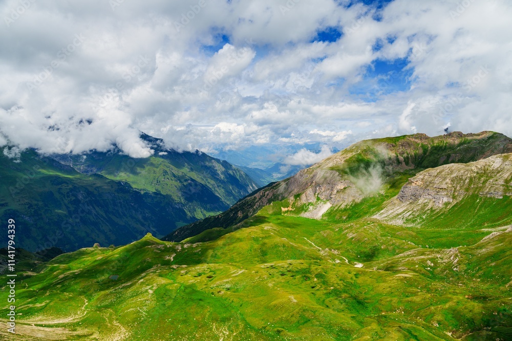 Fototapeta premium This stunning image showcases the majestic beauty of Kaprun, Austria, featuring lush green hills and towering mountains that create a breathtaking landscape, perfect for outdoor activities.