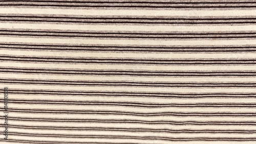 A close-up of a textured brown corrugated cardboard surface with striped lines, creating a seamless pattern of material and design photo