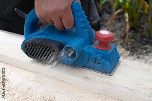 Worker is planing boards photo
