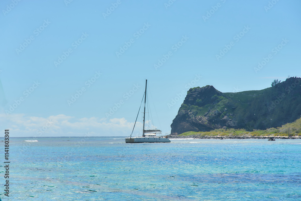 Île Plate (Flat Island) is a picturesque island in the Indian Ocean with a catamaran near located off the northern coast of Mauritius. Île Plate (Flat Island) is a picturesque island in the Indian Ocean with a catamaran near located off the northern coast of Mauritius.