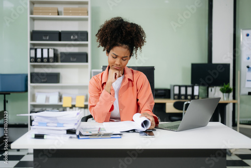 Young businesswoman working with working notepad, tablet and laptop documents talking on the smartphone, tablet photo