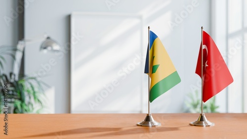 FLAGS OF SAINT VINCENT AND TURKEY ON TABLE photo