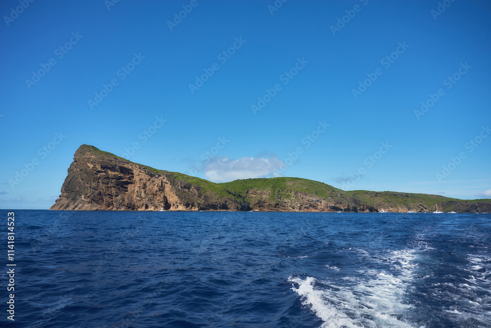Fototapeta premium Coin de Mire (Gunner's Quoin), a protected Mauritian island 8 km off Mauritius' northern coast, is known for its steep profile and birdlife but is not open to visitors.