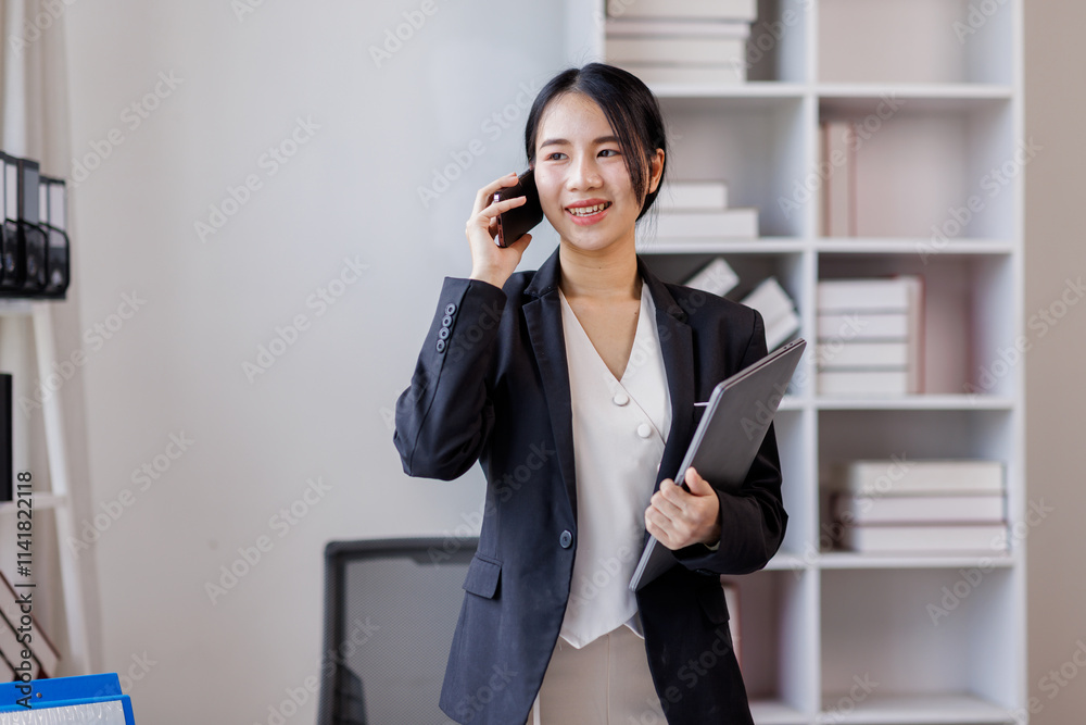 Cheerful business Asian woman freelancer making telephone call share good news about project working in office workplace, business finance concept.
Cheerful business Asian woman freelancer making telephone call share good news about project working in office workplace, business finance concept.
