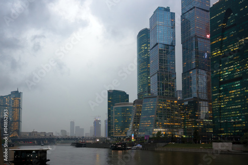 Skyscrapers by the river in cloudy weather photo