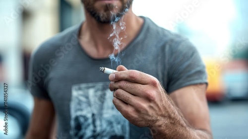 Man smoking a cigarette on city street urban lifestyle close-up view capturing habitual moments
