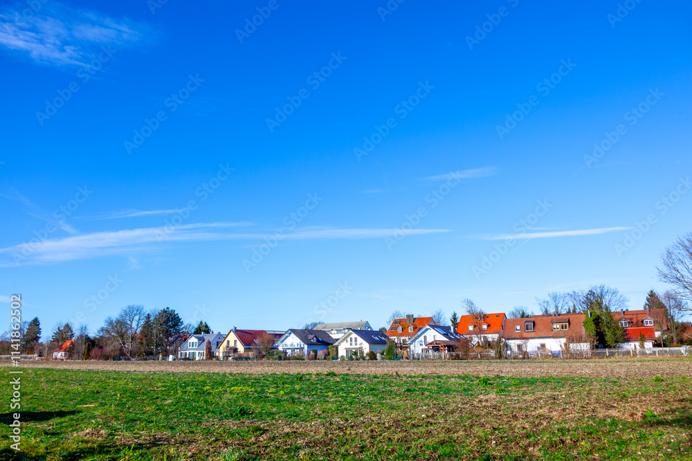Naklejka premium suburban area of munich with fields and family houses at horizon, Munich, Germany
