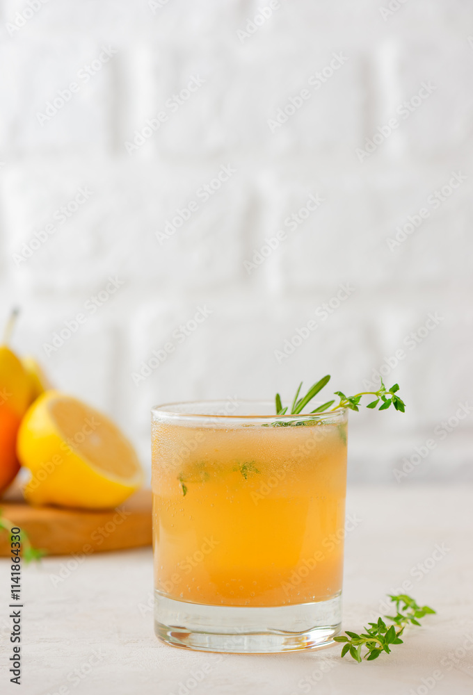 Cocktail with pear, lemon, rosemary, thyme and ice in a glass. Healthy drink, sugar and alcohol free. Vertical orientation. Cocktail with pear, lemon, rosemary, thyme and ice in a glass. Healthy drink, sugar and alcohol free. Vertical orientation.