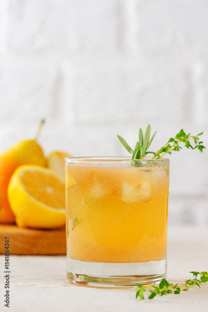 Cold pear cocktail, lemonade with lemon, rosemary, thyme and ice in a glass on a white background. Healthy drink, sugar and alcohol free. Vertical orientation. Cold pear cocktail, lemonade with lemon, rosemary, thyme and ice in a glass on a white background. Healthy drink, sugar and alcohol free. Vertical orientation.